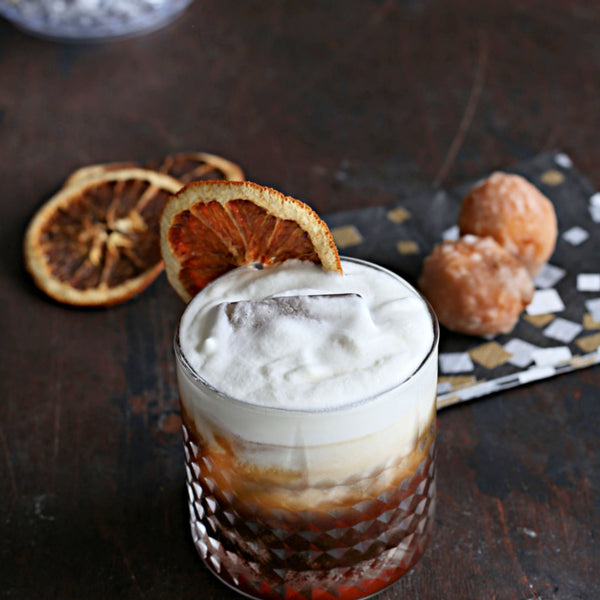 Cold Brew Old Fashioned zero proof mocktail served over ice with an orange wheel garnish