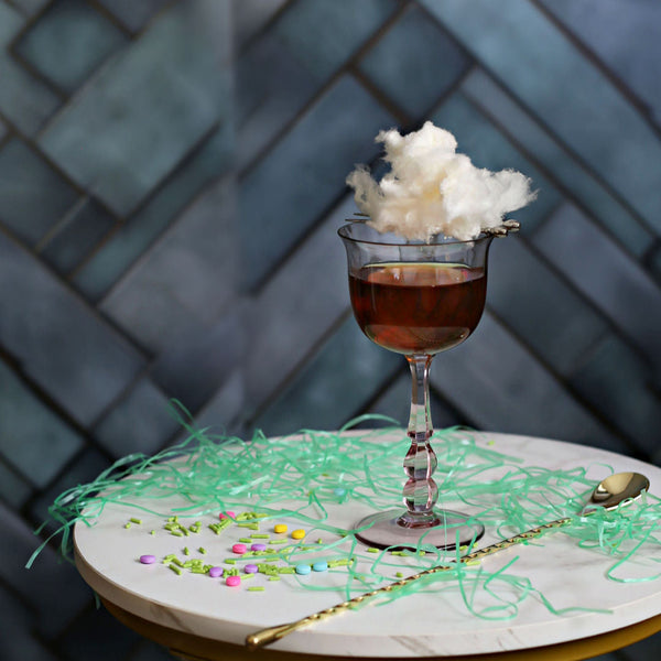 A Maple Cotton Candy Old Fashioned with whiskey, maple syrup, and Rustic Oak Traditional Mixer, topped with a fluffy maple cotton candy garnish.