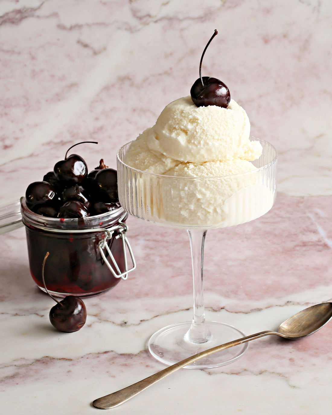 Scoops of homemade bourbon barrel ice cream made with Rustic Oak Barrel Aged Mixer, heavy cream, and warm spices in a bowl.