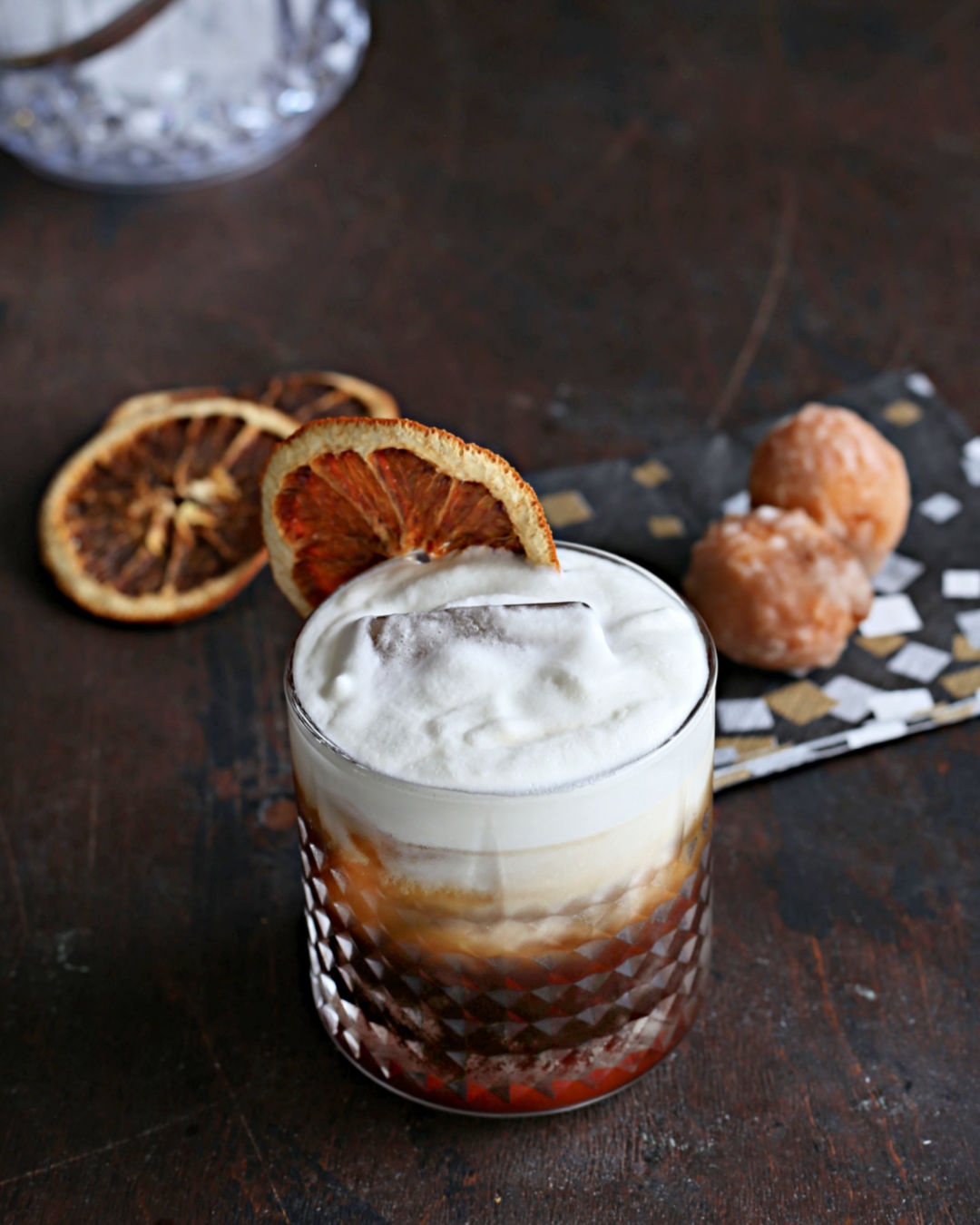 Cold Brew Old Fashioned zero proof mocktail served over ice with an orange wheel garnish