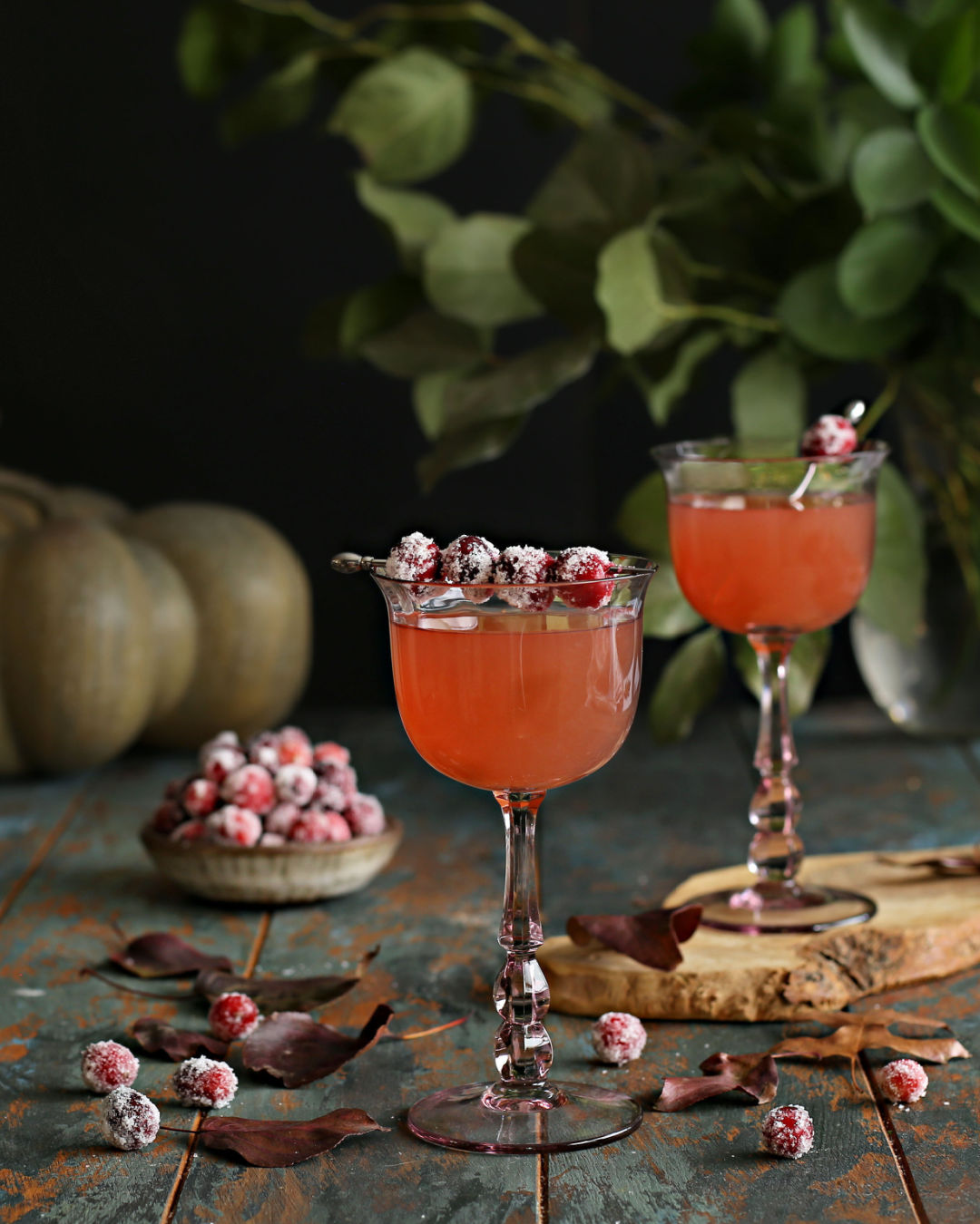 A Cranberry Gimlet cocktail with gin, lime, cranberry juice, and Rustic Oak Barrel Aged Mixer, garnished with sugared cranberries.
