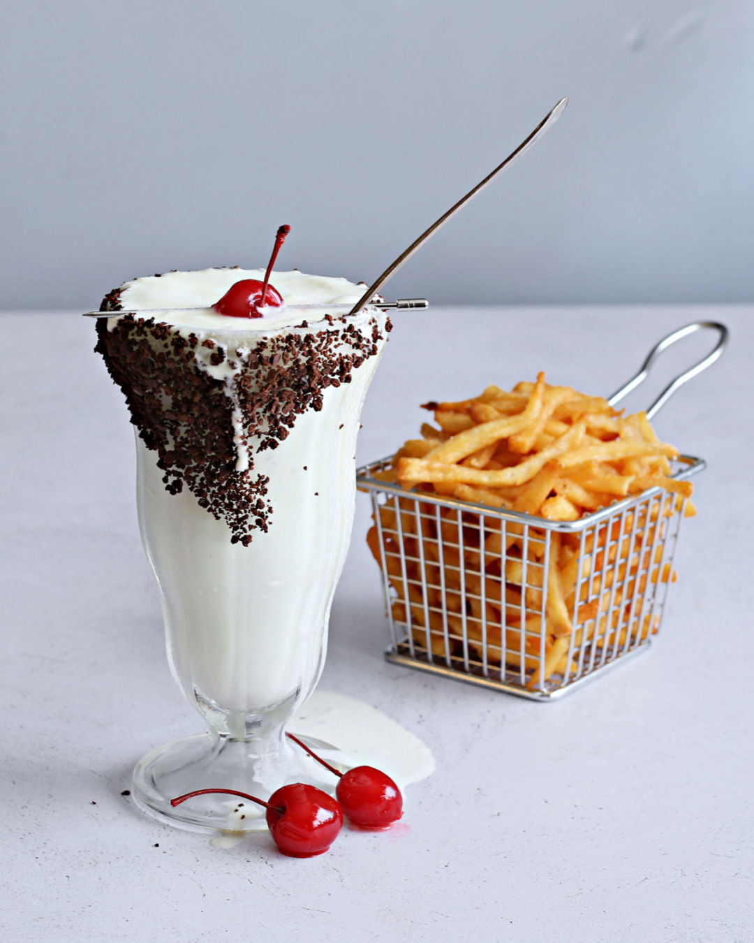 Vanilla bourbon milkshake topped with chocolate sprinkles and a maraschino cherry
